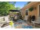 Relaxing back patio with seating, a colorful rug, and a view of the backyard greenery, perfect for outdoor enjoyment at 7918 Yester Ct, Raleigh, NC 27615