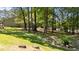 Picturesque backyard with mature trees, a rock bed and plenty of space for outdoor activities and relaxation at 7918 Yester Ct, Raleigh, NC 27615