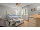 Bright bedroom with hardwood floors, comfortable bed, natural light, and a view of the backyard at 7918 Yester Ct, Raleigh, NC 27615