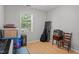 Bedroom with wood floors and natural light streaming through the window at 7918 Yester Ct, Raleigh, NC 27615