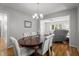 Elegant dining room featuring hardwood floors, table with seating for six and natural light at 7918 Yester Ct, Raleigh, NC 27615
