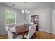 Bright dining room with an oval wood table, upholstered chairs, and elegant china cabinet at 7918 Yester Ct, Raleigh, NC 27615