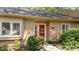 Home's red front door with lush plants at 7918 Yester Ct, Raleigh, NC 27615