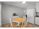 Kitchen featuring updated appliances, light cabinets, breakfast table and access to backyard at 7918 Yester Ct, Raleigh, NC 27615