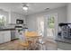 Eat-in kitchen with stainless steel appliances, and a breakfast table with access to the patio at 7918 Yester Ct, Raleigh, NC 27615