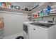 Functional laundry room featuring modern washer and dryer units at 7918 Yester Ct, Raleigh, NC 27615