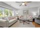 Bright living room with two sofas, a glass coffee table, a ceiling fan and natural light at 7918 Yester Ct, Raleigh, NC 27615