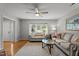 Open-concept living area featuring lots of natural light, comfortable sofas and a ceiling fan at 7918 Yester Ct, Raleigh, NC 27615