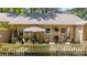 Charming outdoor patio with seating and a white picket fence at 7918 Yester Ct, Raleigh, NC 27615