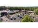 Well-maintained shopping center with a variety of stores and expansive parking, nestled amongst mature trees and landscaping at 7918 Yester Ct, Raleigh, NC 27615