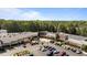 Shopping center with ample parking, a variety of stores and outdoor seating, set against a backdrop of lush greenery at 7918 Yester Ct, Raleigh, NC 27615