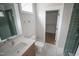 Bright bathroom with a tiled shower, and a vanity with drawers and a sink at 7932 Wexford Waters Ln, Wake Forest, NC 27587
