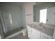 Modern bathroom featuring glass shower, white vanity with a countertop sink, and neutral tile floors at 7932 Wexford Waters Ln, Wake Forest, NC 27587
