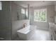 Modern bathroom with freestanding tub, glass shower, and double vanity sinks at 7932 Wexford Waters Ln, Wake Forest, NC 27587