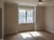 Bedroom with hardwood floors, a large window, and neutral walls at 7932 Wexford Waters Ln, Wake Forest, NC 27587