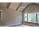 Bedroom featuring vaulted ceiling, modern ceiling fan, and wooded views from three windows at 7932 Wexford Waters Ln, Wake Forest, NC 27587