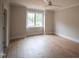 Bright bedroom features a ceiling fan, natural light from a window, and light wood floors at 7932 Wexford Waters Ln, Wake Forest, NC 27587