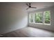 Bright bedroom with a ceiling fan and large windows offering a beautiful view at 7932 Wexford Waters Ln, Wake Forest, NC 27587