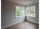 Bright bedroom featuring large windows and hardwood floors at 7932 Wexford Waters Ln, Wake Forest, NC 27587