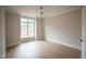 A bedroom filled with natural light featuring a ceiling fan and hardwood floors at 7932 Wexford Waters Ln, Wake Forest, NC 27587