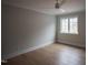 Well-lit bedroom boasts wood floors, a ceiling fan, and a window offering exterior views at 7932 Wexford Waters Ln, Wake Forest, NC 27587