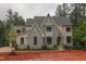 Two-story home with painted brick, gabled roof, and arched front entry at 7932 Wexford Waters Ln, Wake Forest, NC 27587