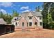 Charming two-story home featuring brick and siding exterior, black window trim, and lush, natural surroundings at 7932 Wexford Waters Ln, Wake Forest, NC 27587