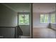 A foyer featuring hardwood floors, staircase, and large windows at 7932 Wexford Waters Ln, Wake Forest, NC 27587