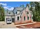 This charming home features a beautiful brick facade, a grey roof, and black window frames at 7932 Wexford Waters Ln, Wake Forest, NC 27587