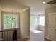Hallway leads to a bright bonus room with large windows and natural light at 7932 Wexford Waters Ln, Wake Forest, NC 27587