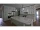 Bright kitchen features large island, white cabinets, and stainless steel appliances at 7932 Wexford Waters Ln, Wake Forest, NC 27587