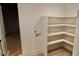 Bright laundry room with built in white shelves and a utility sink hookup at 7932 Wexford Waters Ln, Wake Forest, NC 27587