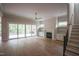 Open-concept living room features fireplace, built-in shelving, and access to patio at 7932 Wexford Waters Ln, Wake Forest, NC 27587