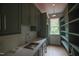 Mudroom with shelving, sink, and ample counter space and hardwood floors at 7932 Wexford Waters Ln, Wake Forest, NC 27587