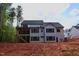 The back of this two story home features a screened in back porch overlooking the private lot at 7932 Wexford Waters Ln, Wake Forest, NC 27587