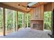 Inviting screen porch featuring brick fireplace with tongue and groove ceiling at 7932 Wexford Waters Ln, Wake Forest, NC 27587