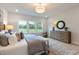 Bright bedroom with view of backyard, light neutral decor, and hardwood floors at 87 Addison Pond Ct # 12, Zebulon, NC 27597