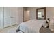 Bright bedroom with a large decorative mirror and closet doors at 87 Addison Pond Ct # 12, Zebulon, NC 27597