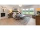 Spacious bedroom features a large window, hardwood floors and a cozy seating area at 87 Addison Pond Ct # 12, Zebulon, NC 27597