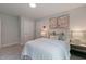 Bright bedroom with neutral decor, features a light-colored bed and complementary artwork at 87 Addison Pond Ct # 12, Zebulon, NC 27597