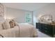 Cozy bedroom with dresser, mirror, and natural light from window at 87 Addison Pond Ct # 12, Zebulon, NC 27597