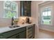 Butler's pantry area with cabinets, wine cooler, sink, and a view to the outside at 87 Addison Pond Ct # 12, Zebulon, NC 27597