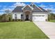 Charming two-story home with stone accents, attached two-car garage, and a well-maintained lawn at 87 Addison Pond Ct # 12, Zebulon, NC 27597