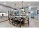 Kitchen with an island, stainless steel appliances, and white cabinets with sleek hardware, showcasing a modern design at 87 Addison Pond Ct # 12, Zebulon, NC 27597