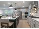 Bright kitchen featuring white cabinetry, stainless steel appliances, and a black island with pendant lighting at 87 Addison Pond Ct # 12, Zebulon, NC 27597