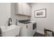 Functional laundry room with modern appliances, white cabinets, and a utility sink at 87 Addison Pond Ct # 12, Zebulon, NC 27597