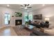Cozy living room with a fireplace and large windows, furnished with sofas and a coffee table at 87 Addison Pond Ct # 12, Zebulon, NC 27597