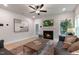 Cozy living room with a fireplace and large windows, furnished with sofas and a coffee table at 87 Addison Pond Ct # 12, Zebulon, NC 27597