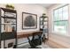 Bright home office with a dark wood desk, black shelving, a window, and neutral decor at 87 Addison Pond Ct # 12, Zebulon, NC 27597