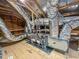 Attic with visible HVAC system, ductwork, and plywood flooring, providing an overview of the home's infrastructure at 87 Addison Pond Ct, Zebulon, NC 27597